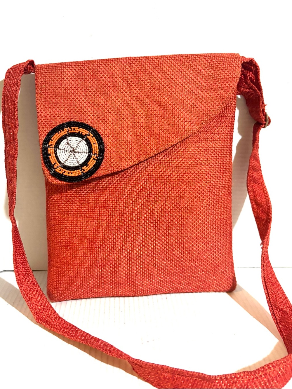 Handwoven Orange Crossbody Bag with Beaded Accent